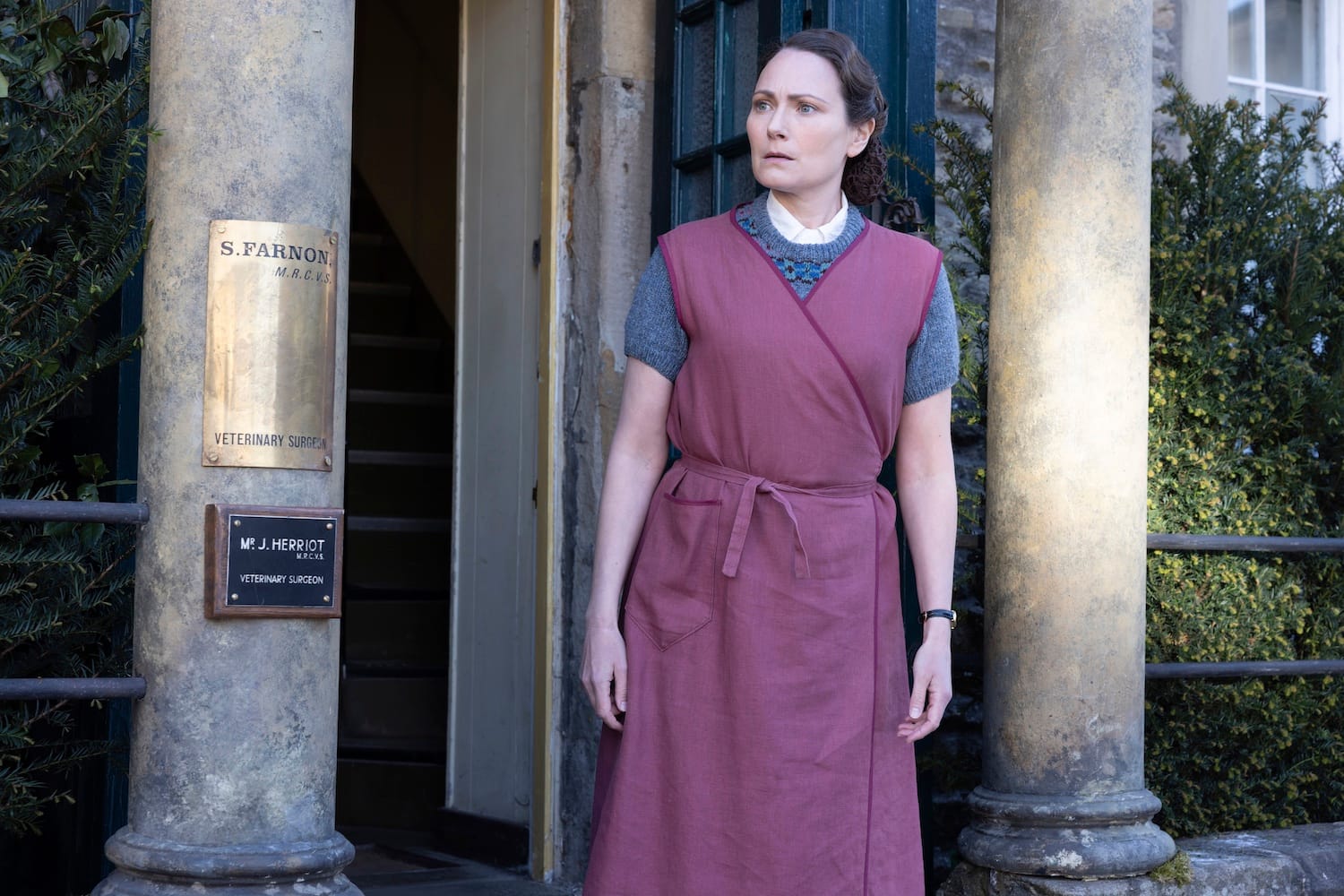 Audrey Hall (Anna Madeley) on the front doorstep of Skeldale House gazes after the woman who returned Siegfried's shoes