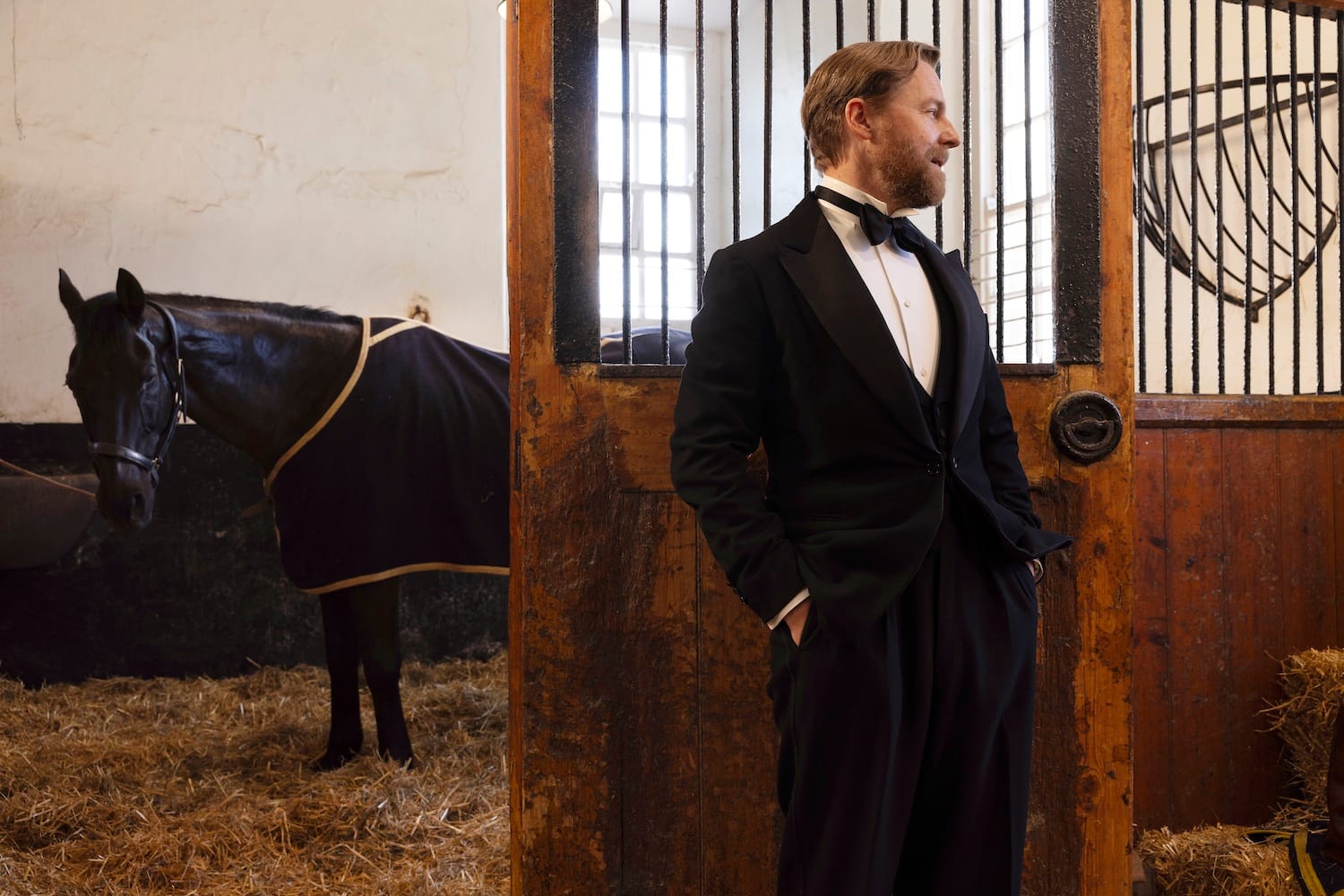 Siegfried (Samuel West) in the stables, extremely dapper in black tie, with Philbright the horse.