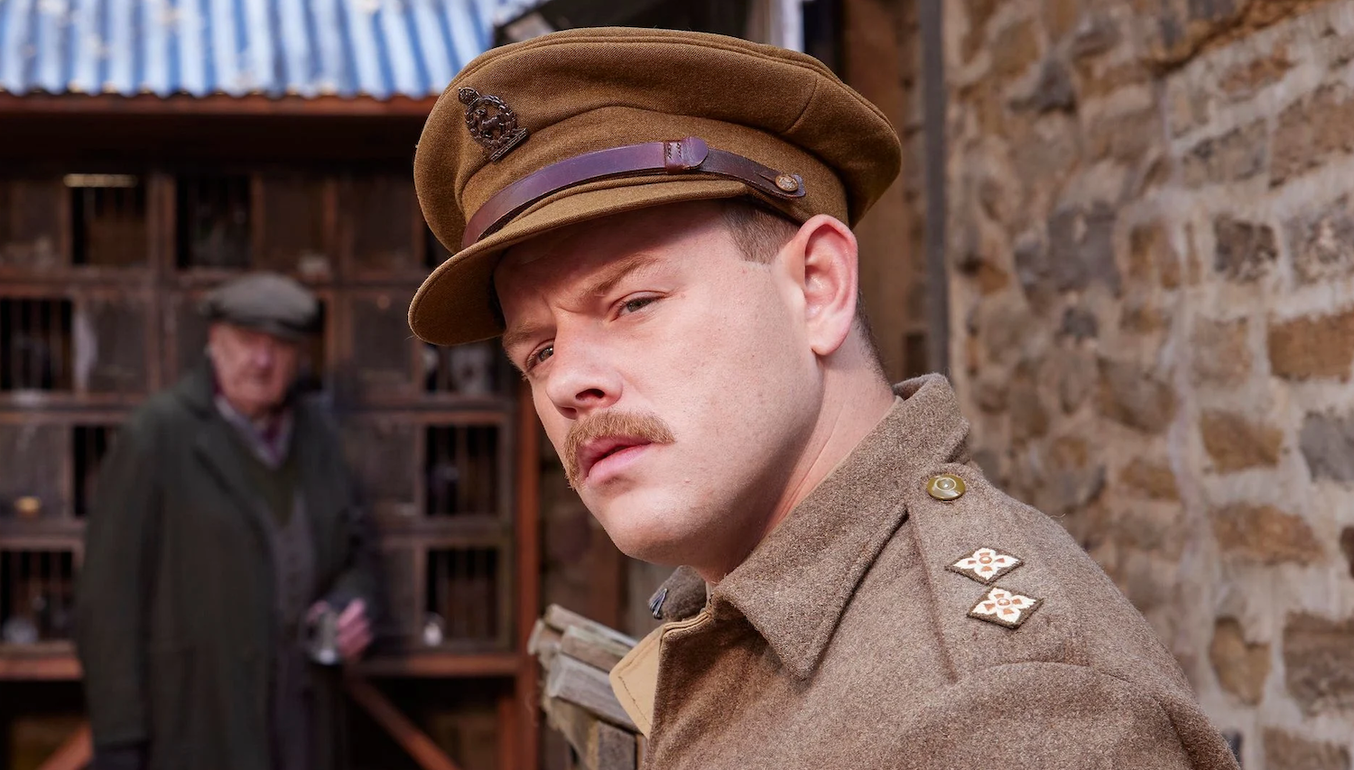 Tristan Farnon (Callum Woodhouse) casts an expert eye on some likely pigeons while their owner lurks in the background.