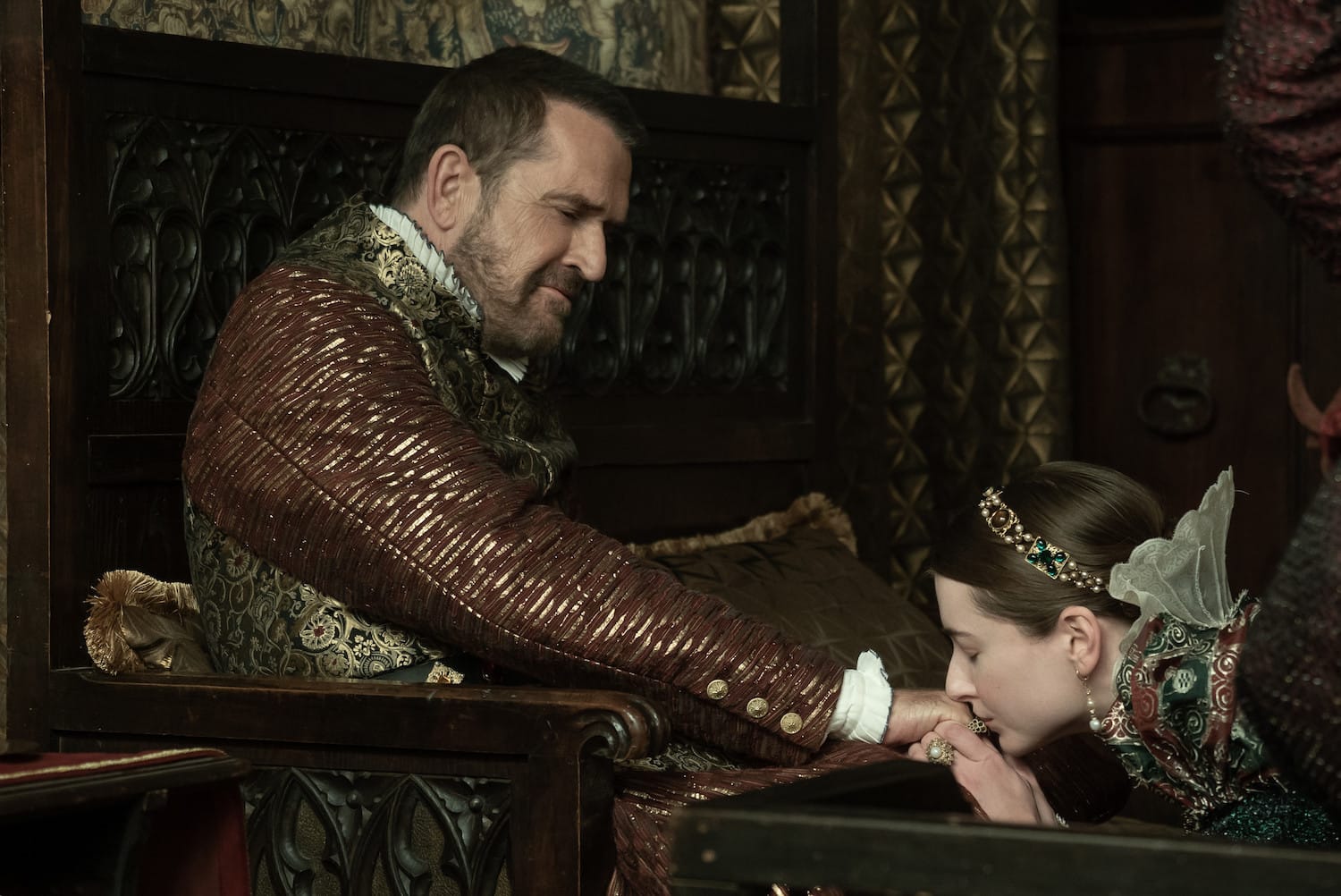 Mary (Antonia Clarke) kneels to kiss the hand of the very appreciative Holy Roman Emperor (Rupert Everett), who has summoned her to meet with him.