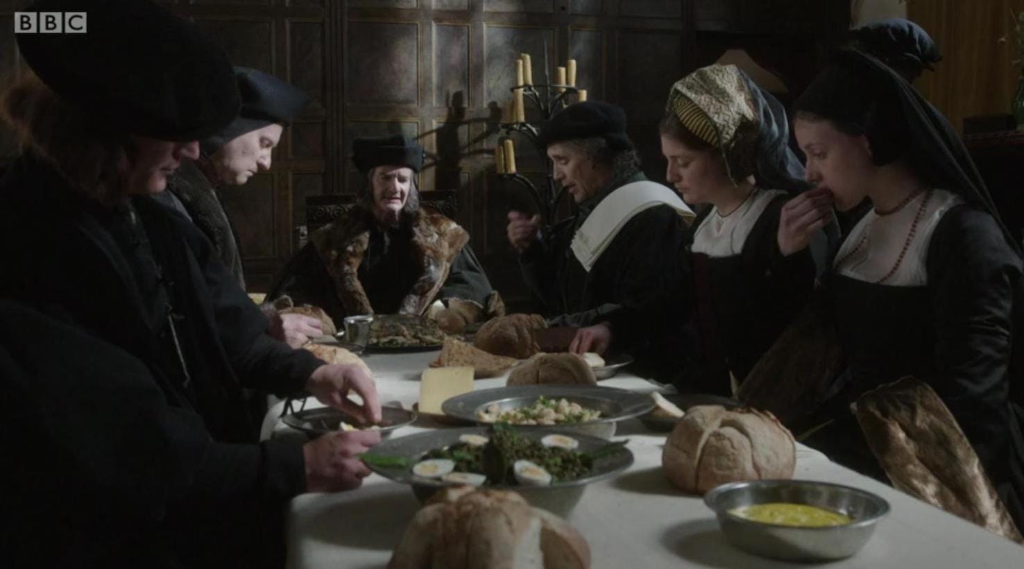 Thomas Cromwell (Mark Rylance) at dinner with Sir Thomas More (Anton Lesser) and his family.