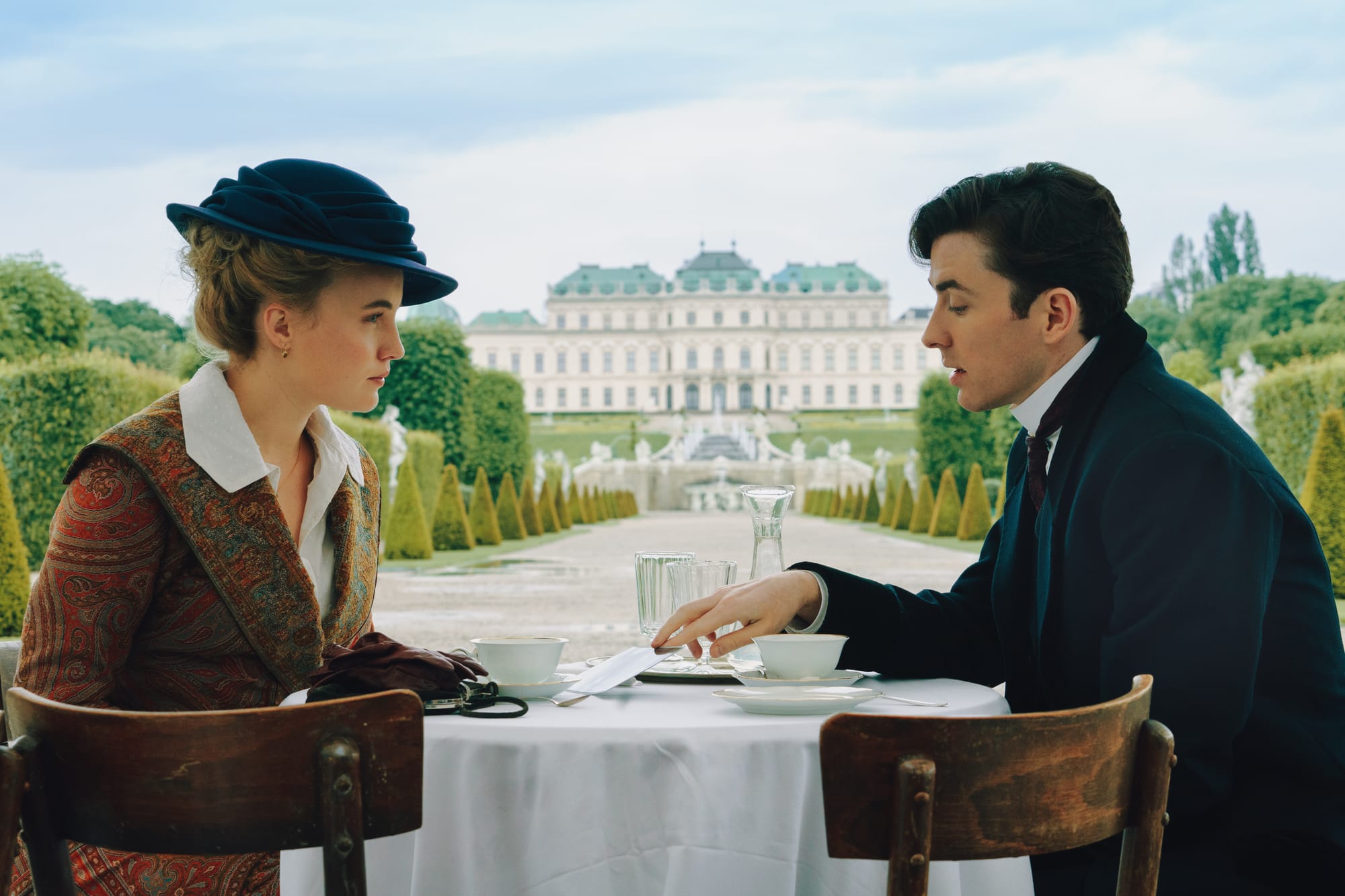 Luise von Finckh and Matthew Beard as Clara and Max, drinking tea in Belevedere Palace Gardens in 'Vienna Blood' Season 3.&nbsp;