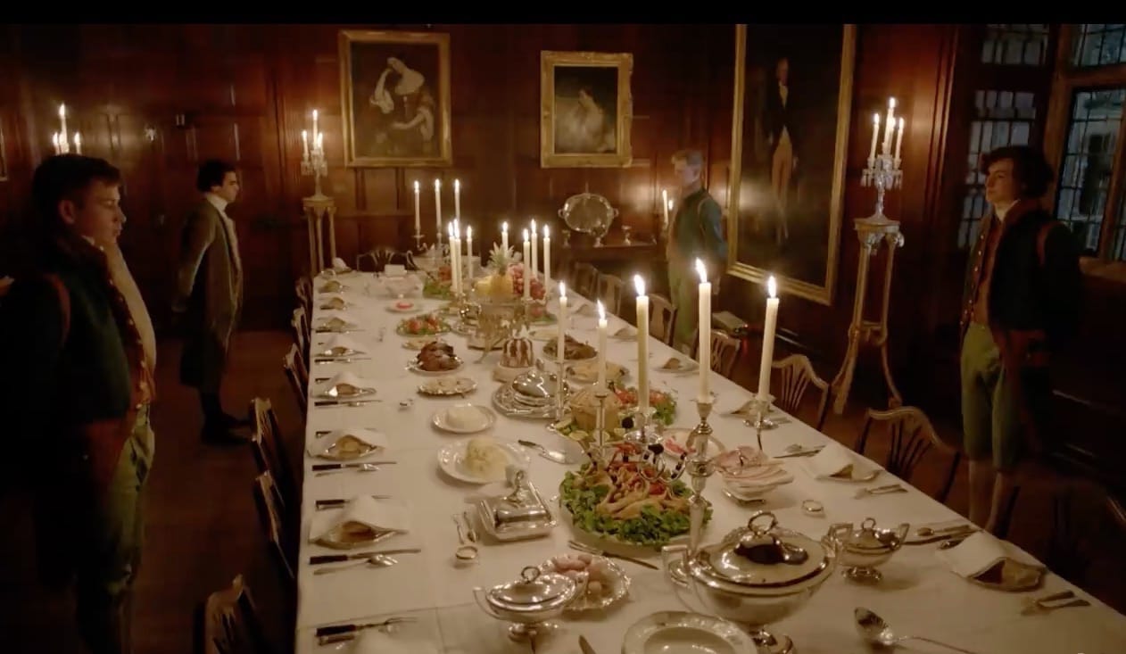 Footmen stand by as hungry guests are about to descend on the dishes of food on the table in the Chawton House dining room.