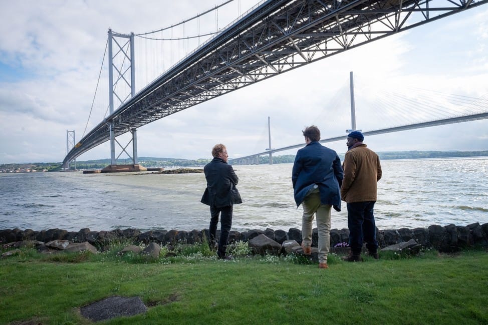 Hiding in plain sight, the three original suspects, Weird (Michael Schaeffer), Ziggy (Alec Newman), and Alex (Buom Tihngang), meet to discuss tactics as the case is reopened.