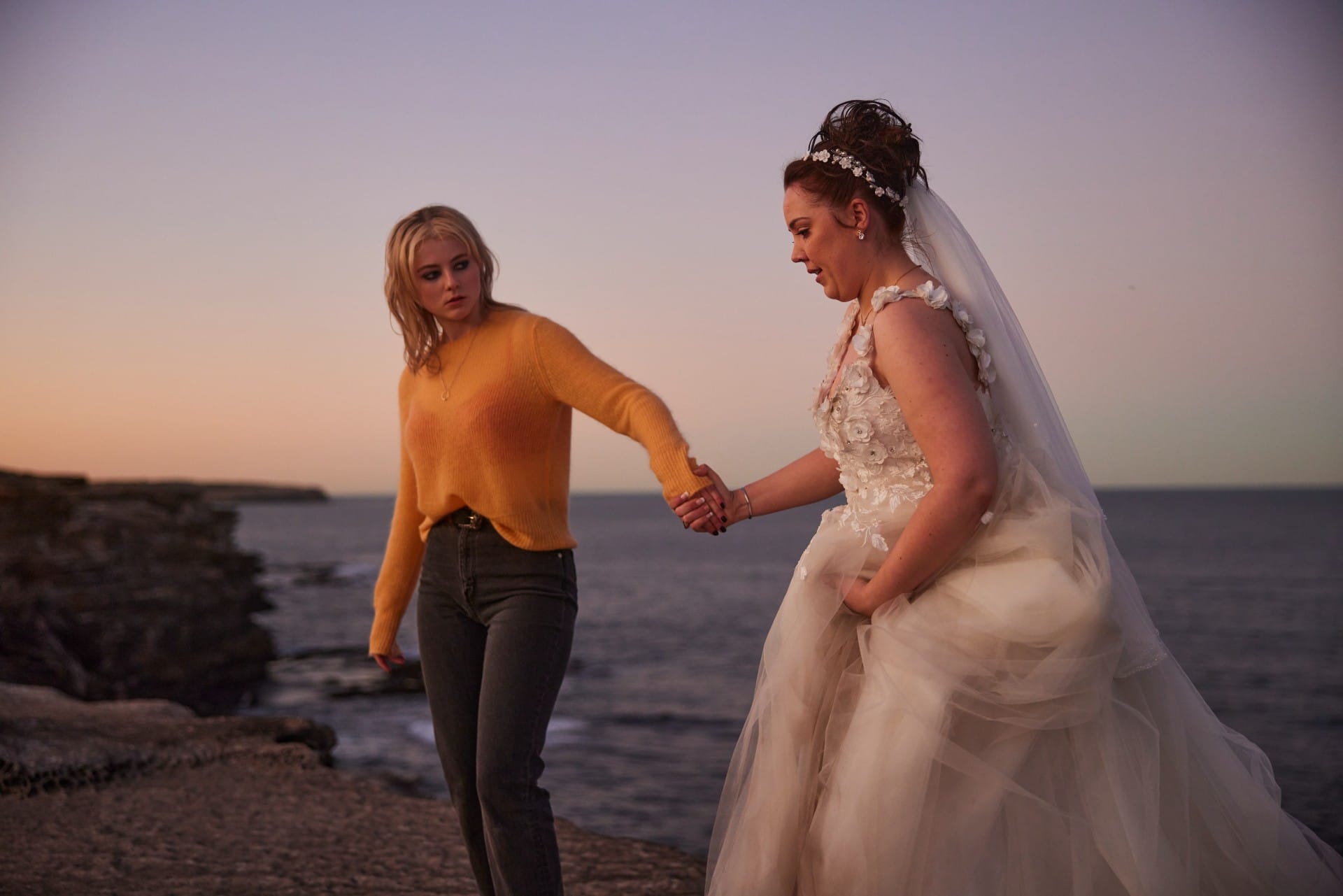 Thomasin McKenzie as Vivian helping clients in Totally Completely Fine