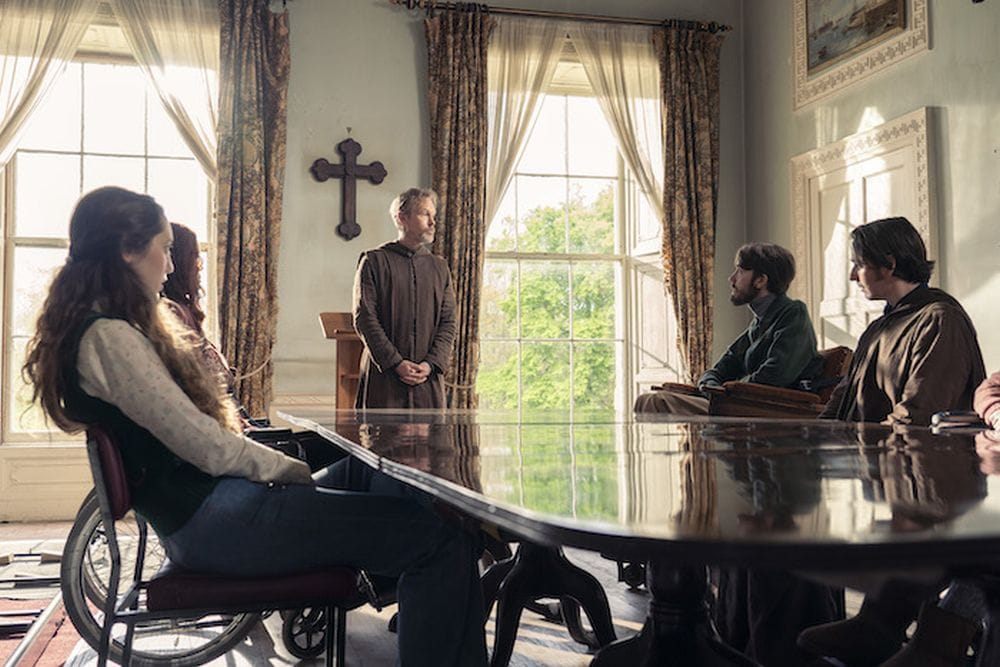 Wilfred (Steven Mackintosh) addresses his flock. Left to right: Maggie (Mirren Mack), Ursula (&nbsp;(Shannon Murray), Henry (George Robinson), and Dennis (Paul Mallon).