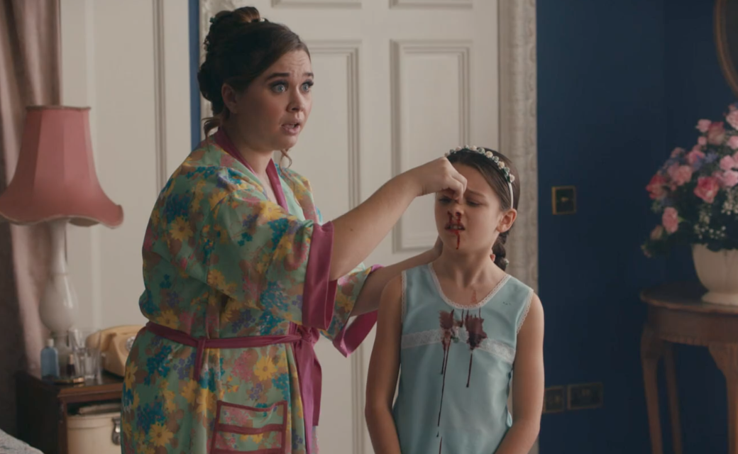 Nurse Nancy (Megan Cusack) tries to stop her daughter Colette's (Francesca Fullilove) nosebleed. 