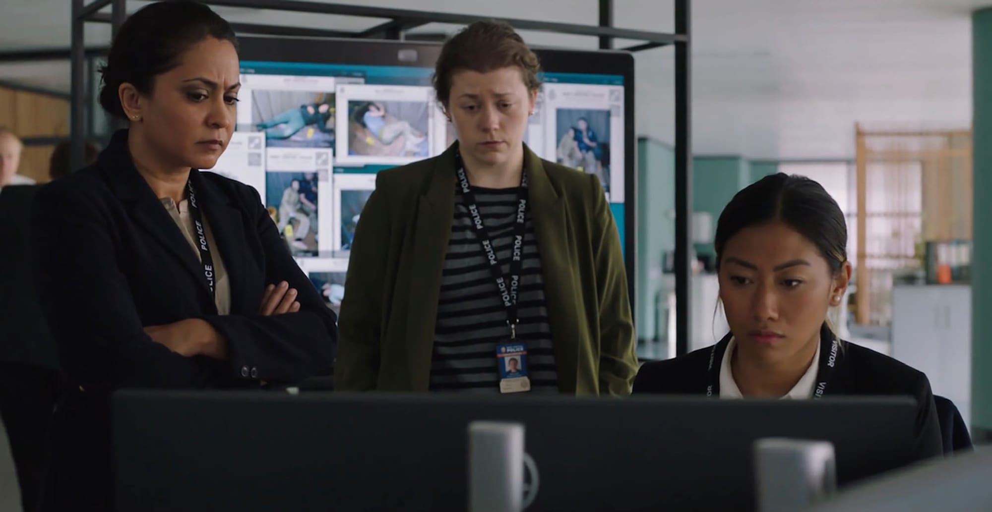 Parminder Nagra as DI Rachita Ray, Jessica Temple as DC Carly Lake, and Jan Le as Min around a computer in DI Ray