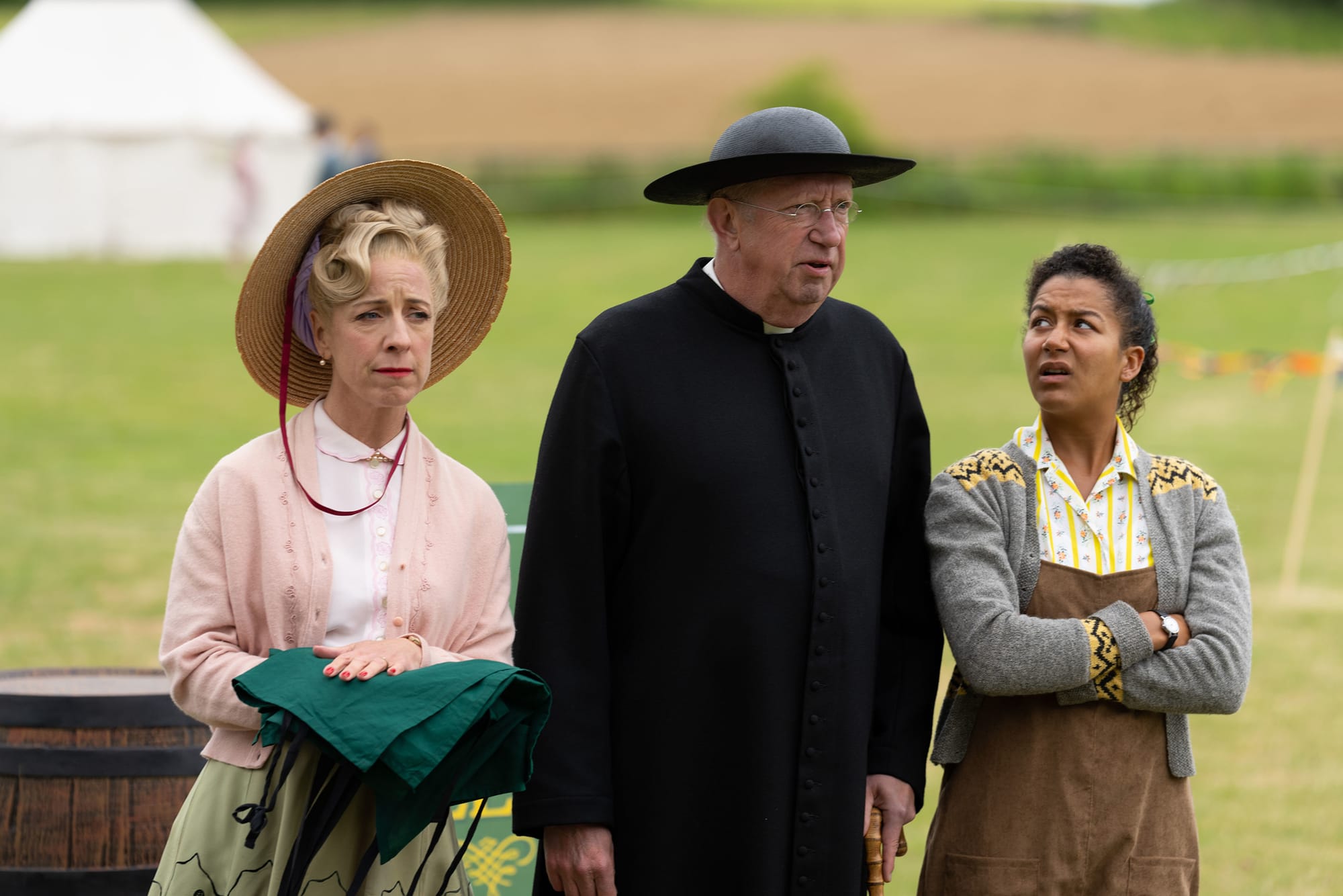 Claudie Blakley as Mrs. Devine, Mark Williams as Father Brown, and Ruby-May Martinwood as Brenda Palmer in 'Father Brown' Season 11