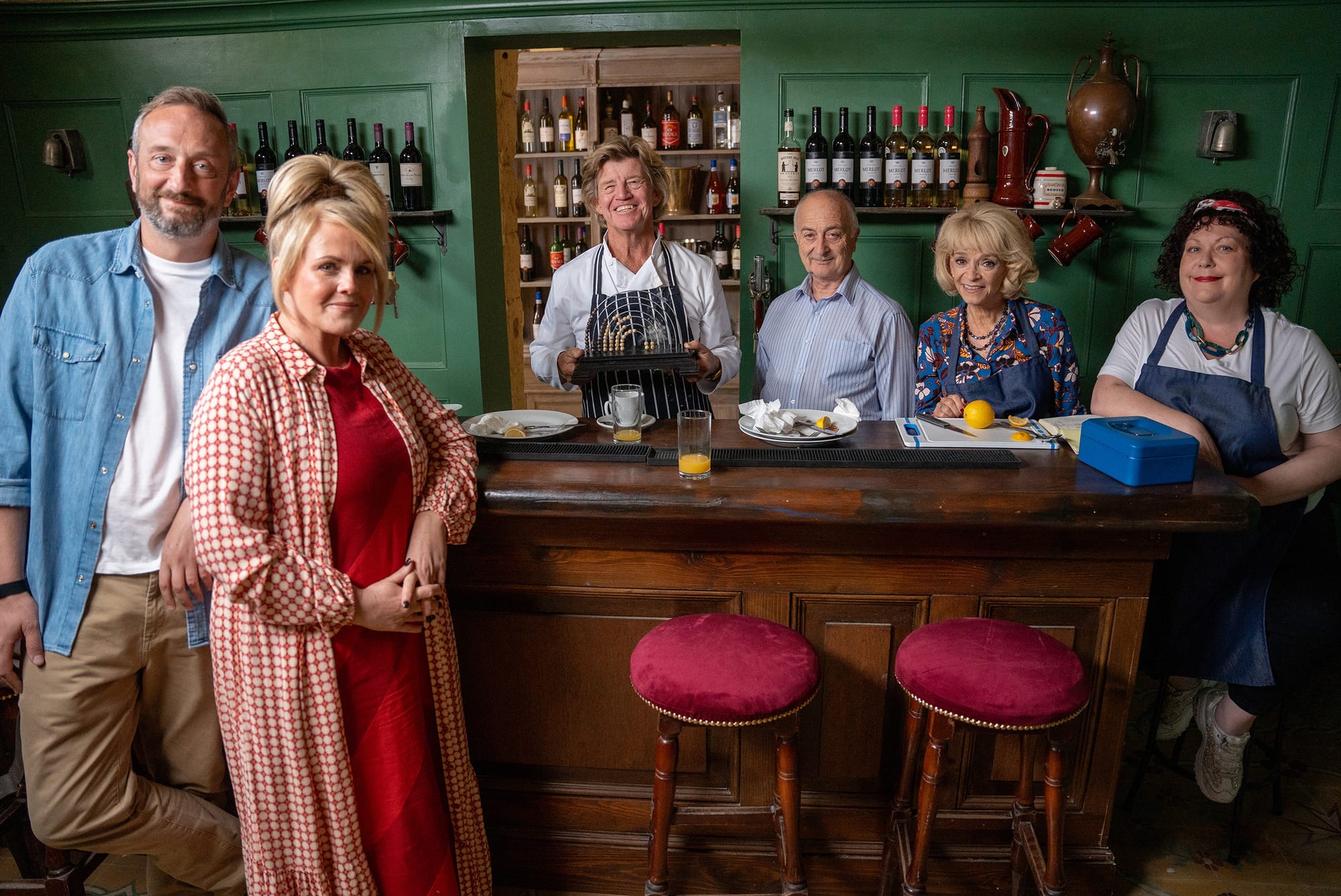 Steve Edge as Dom Hayes, Sally Lindsay as Jean White, Robin Askwith as Jeremy Lloyd James, Tony Robinson as Uncle Patrick, Sue Holderness as Judith Lloyd James, and Sue Vincent as Gloria Beauchamp in The Madame Blanc Mysteries Season 3&nbsp;