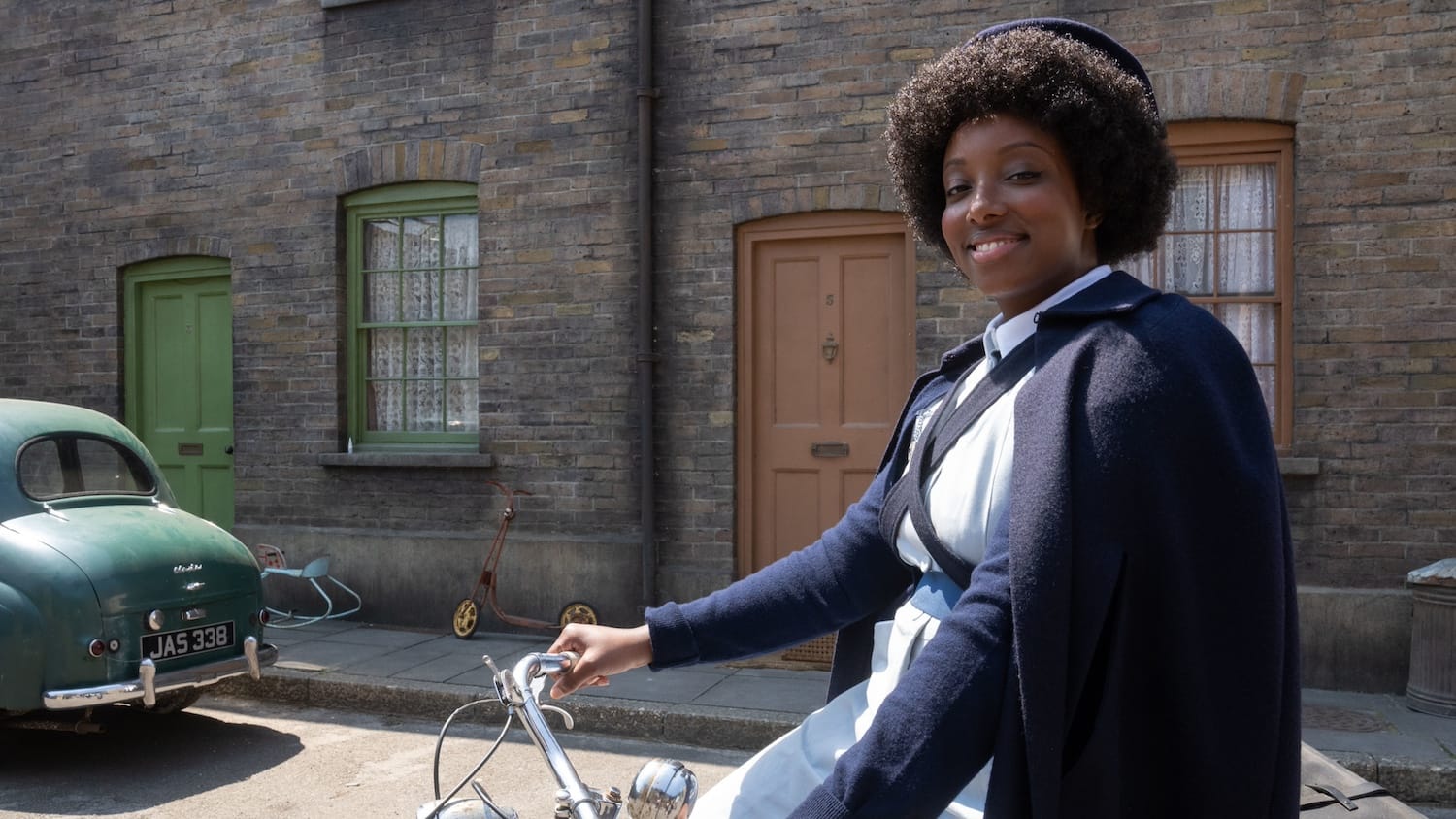 Midwife Joyce Highland (Renee Bailey) on her bike.&nbsp;