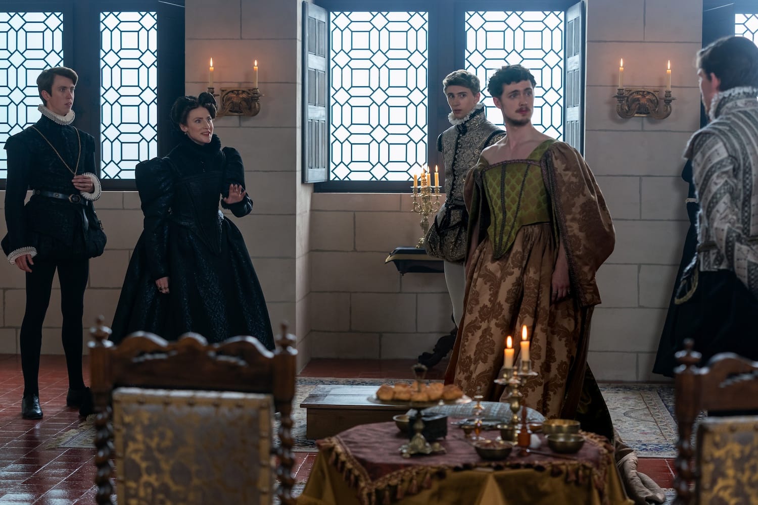 Troublemaker Anjou (Stanley Morgan) sports his sister's dress, amusing Henri de Navarre (Angus Imrie) but appalling his mother Jeanne D'Albret (Rosalie Craig) while Hercules (Scott Folan)and King Charles IX (Bill Milner) watch.