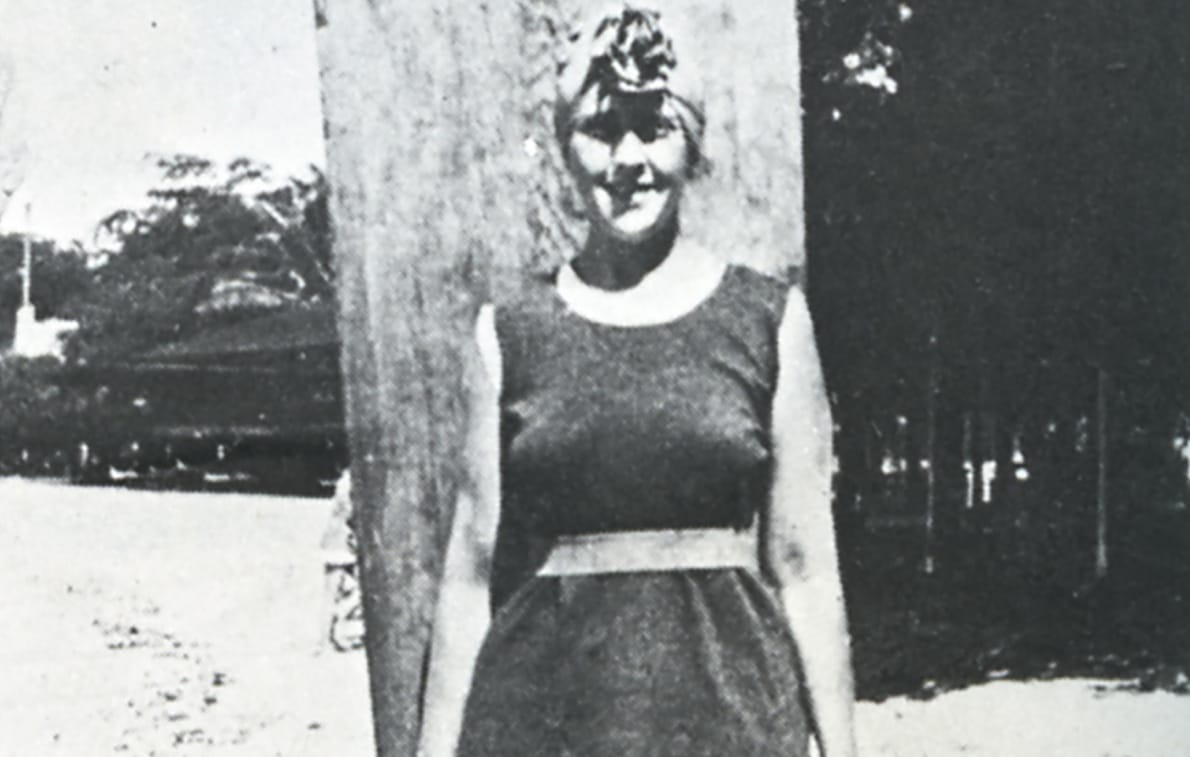 Agatha Christie poses with her surfboard.
