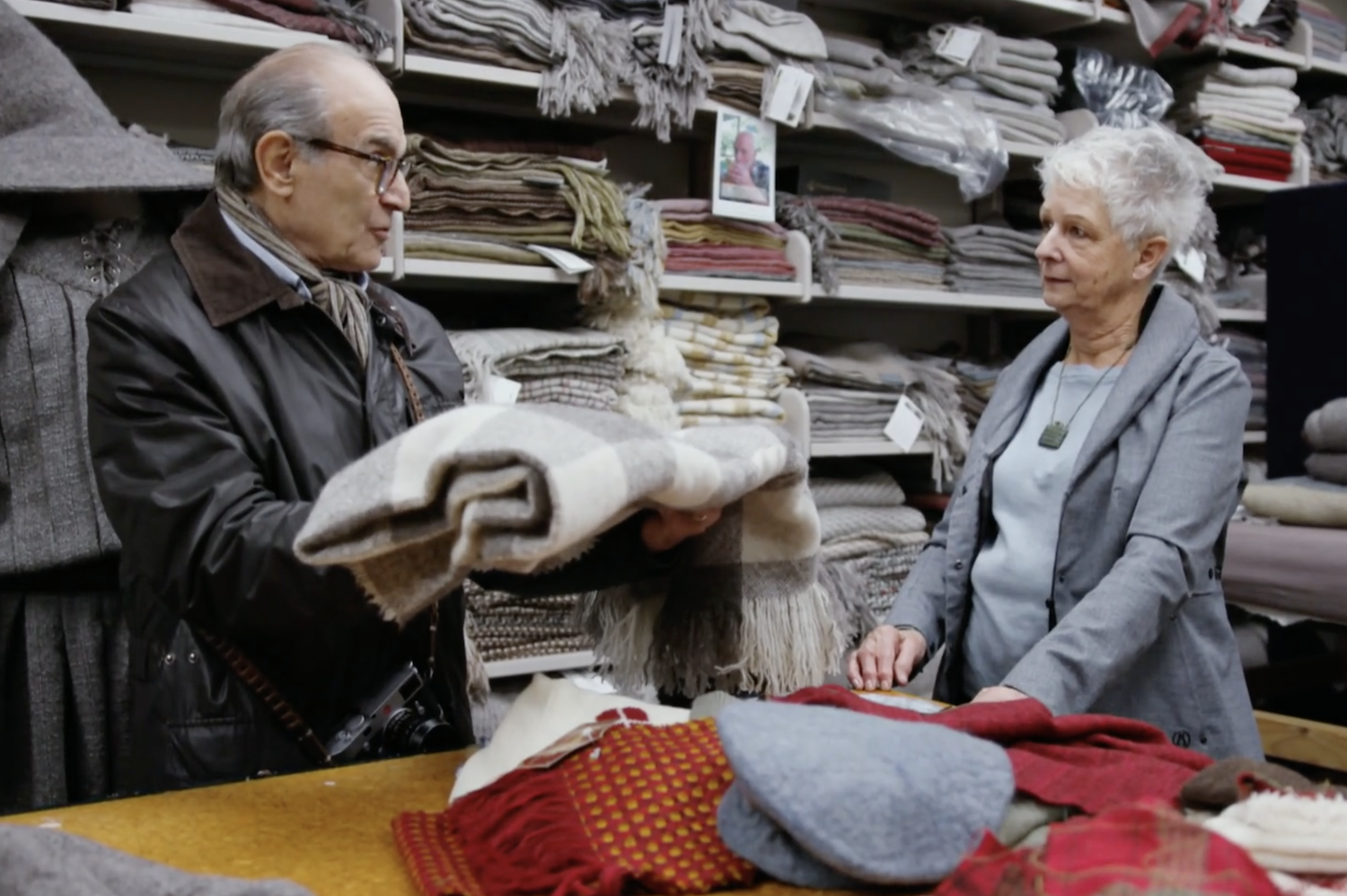A visit to a wool workshop. A Gandalf cloak is behind Suchet.