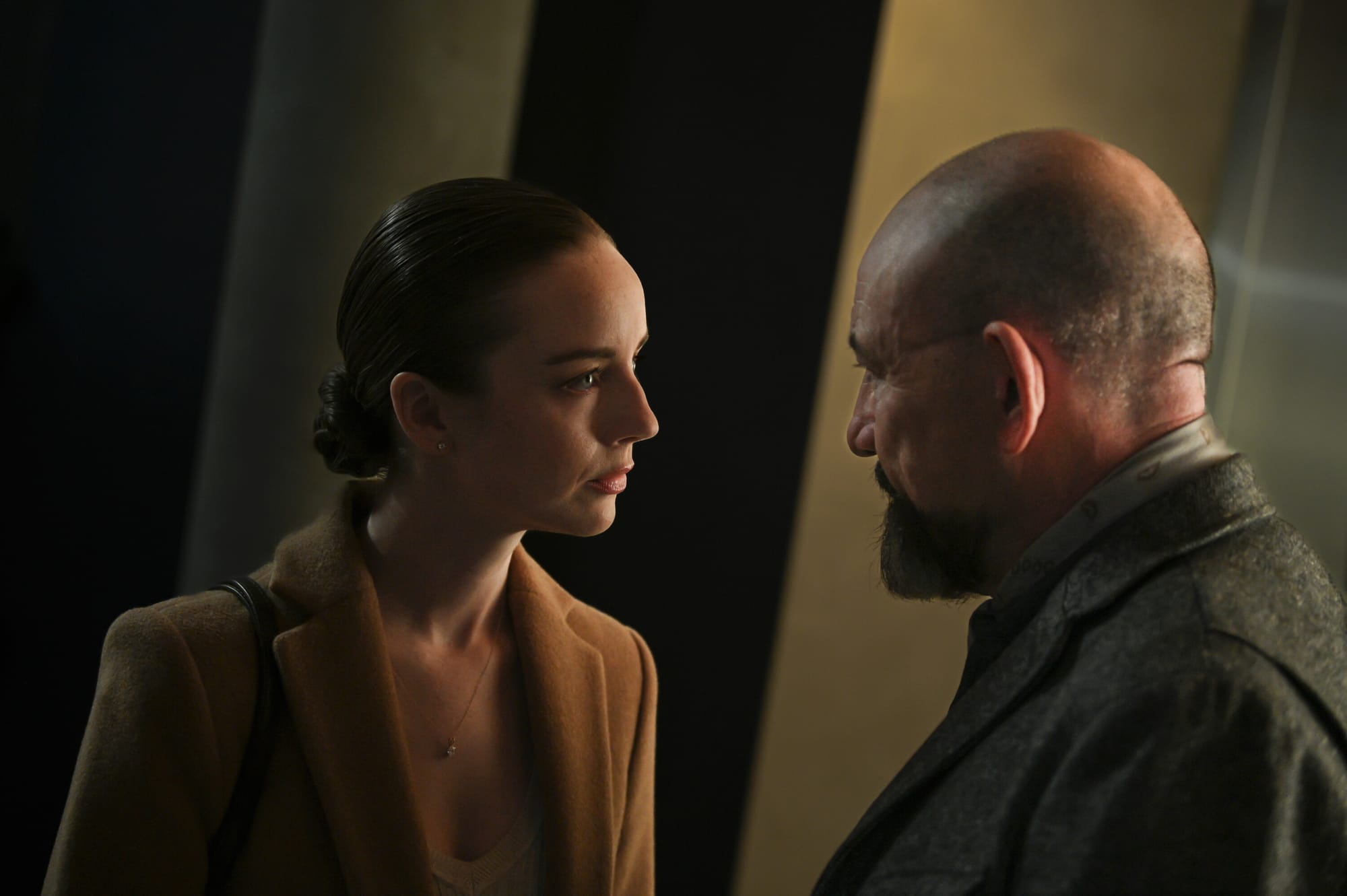 Kacey Rohl as The Rep and Ritchie Coster as Shinwell Johnson in 'Watson' Season 1